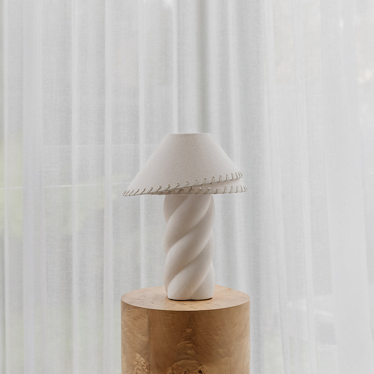 Amalie Table Lamp Small – sculptural ivory ceramic base with curved silhouette and linen shade by Paola And Joy