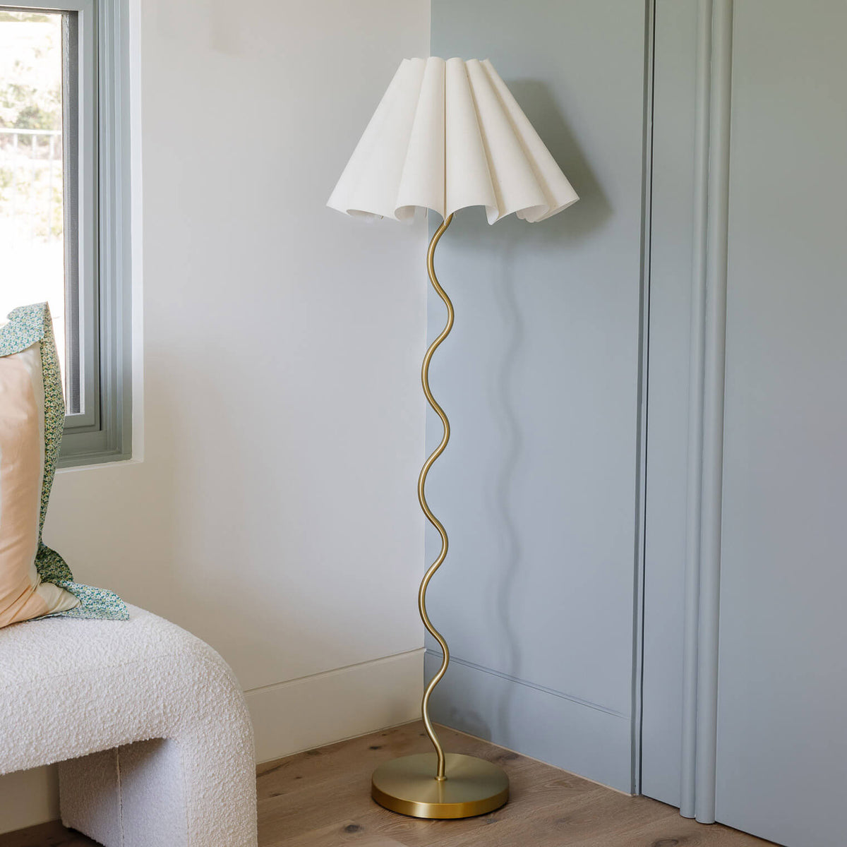 Cora Floor Lamp – detail of the brass squiggly stem from a low angle by Paola And Joy