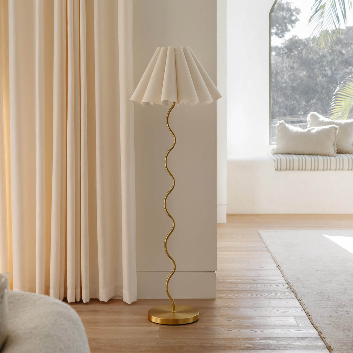 Cora Floor Lamp – view of the floor base of the squiggly brass stem by Paola And Joy
