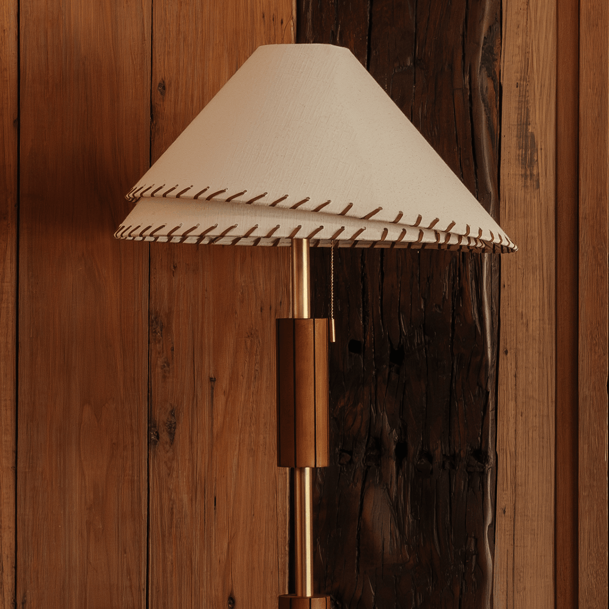Zali Floor Lamp – three-quarter view of the wooden stem and brass-plated base by Paola And Joy
